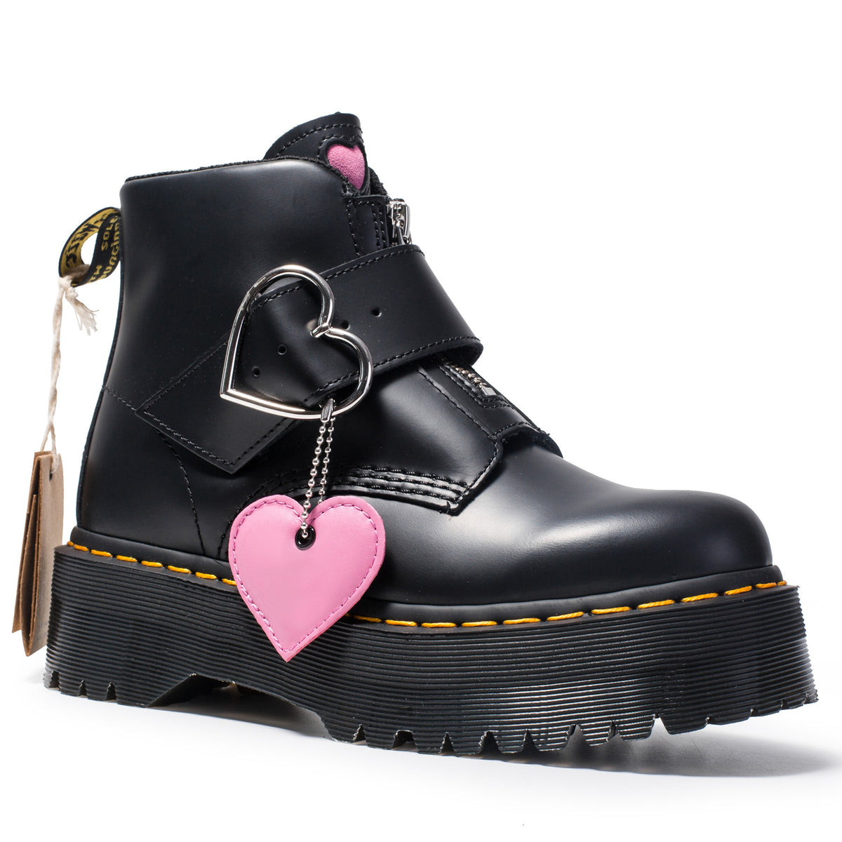 Black boot with pink heart charm on a white background