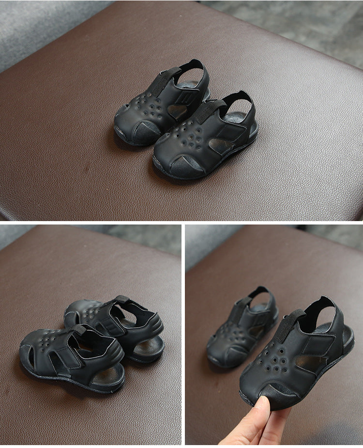 Black children's sandals shown from different angles on a brown surface.