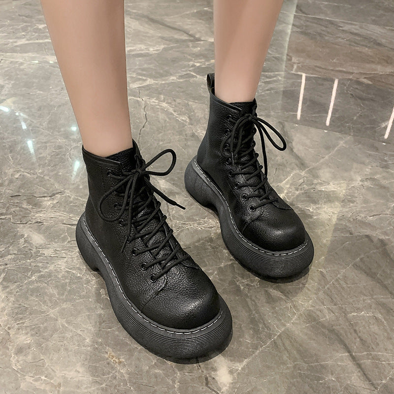 Black leather boots on a marble floor