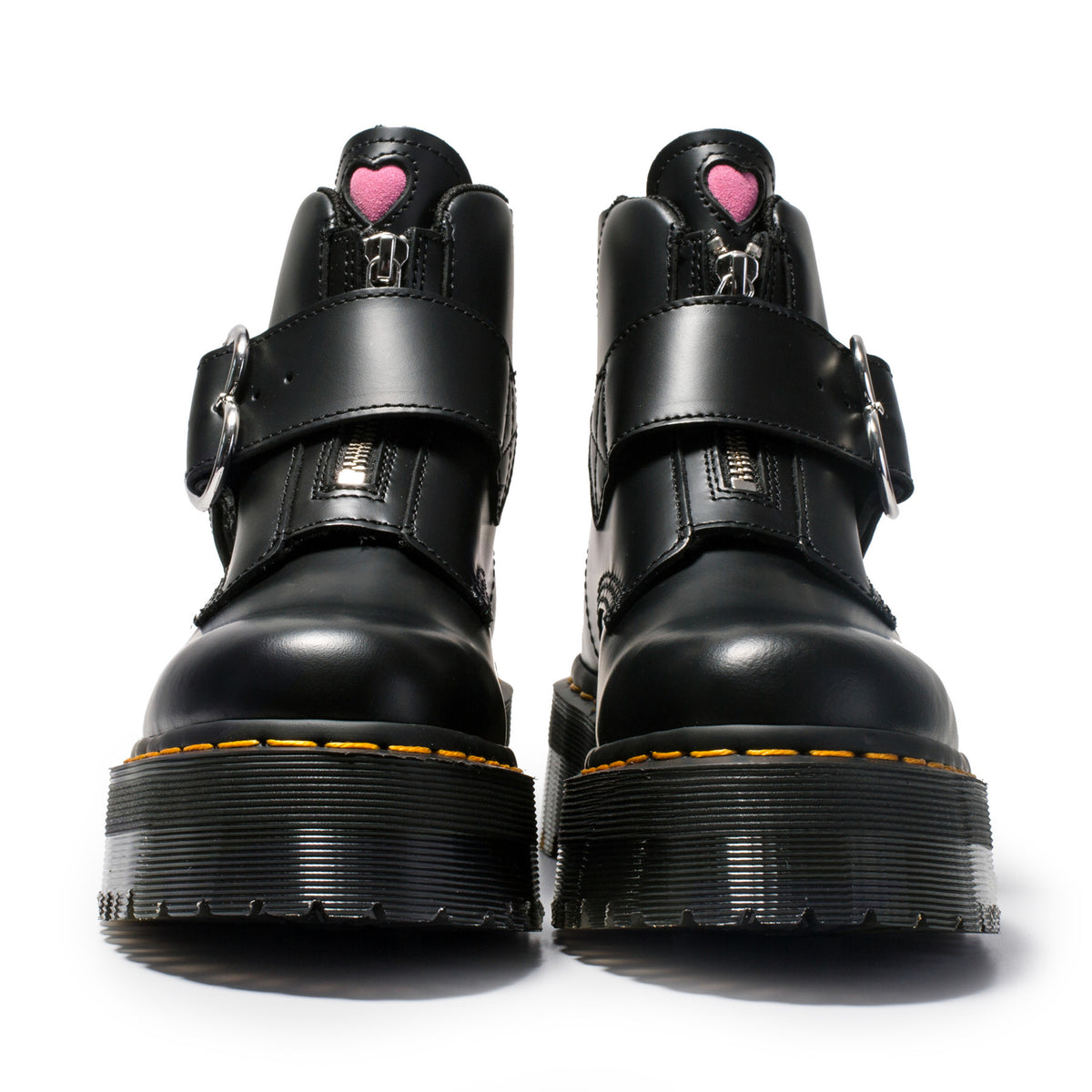 Black platform boots with heart details on a white background