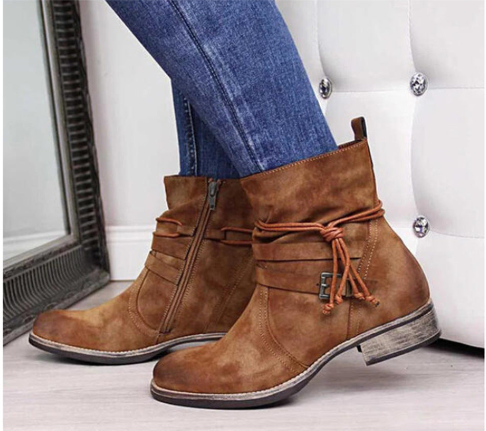Brown ankle boots with blue jeans on a white background