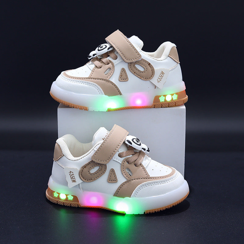 Children's sneakers with colorful LED lights on a gray background