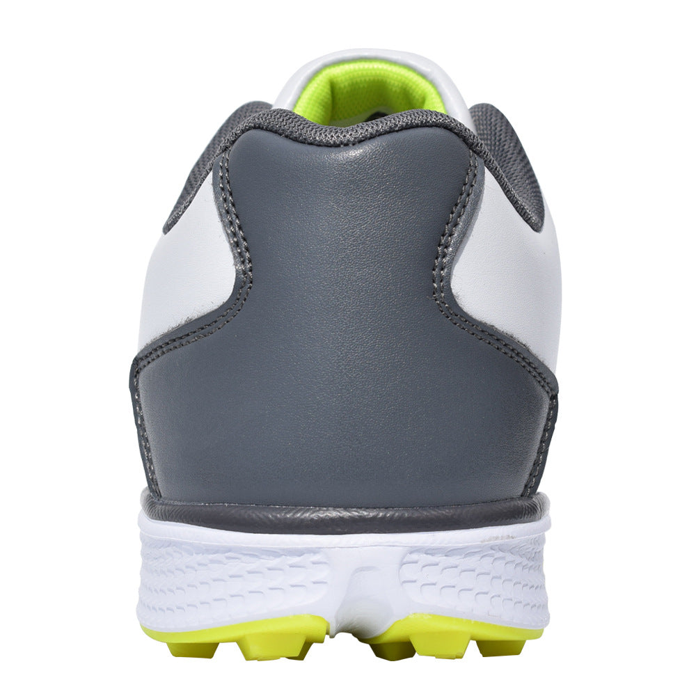 Golf shoe with gray, white, and green sole on a white background