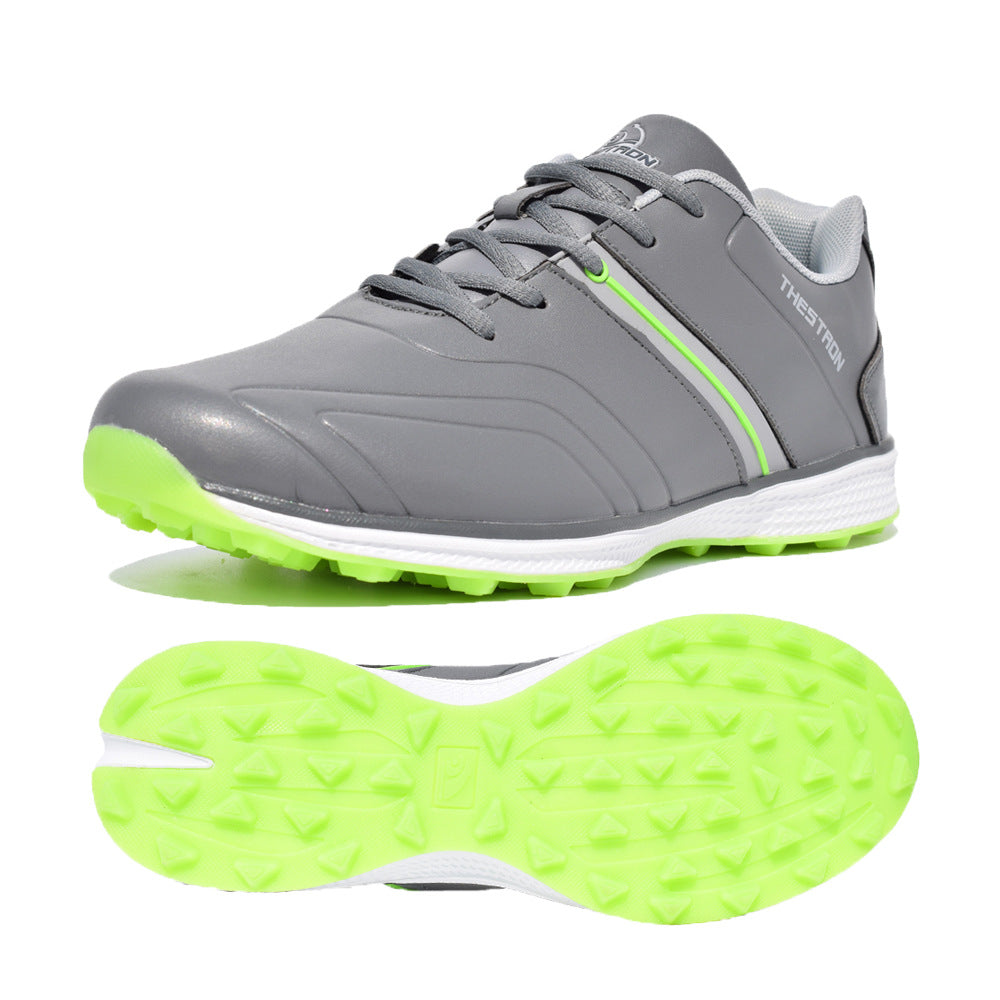 Gray athletic shoe with green sole on a white background