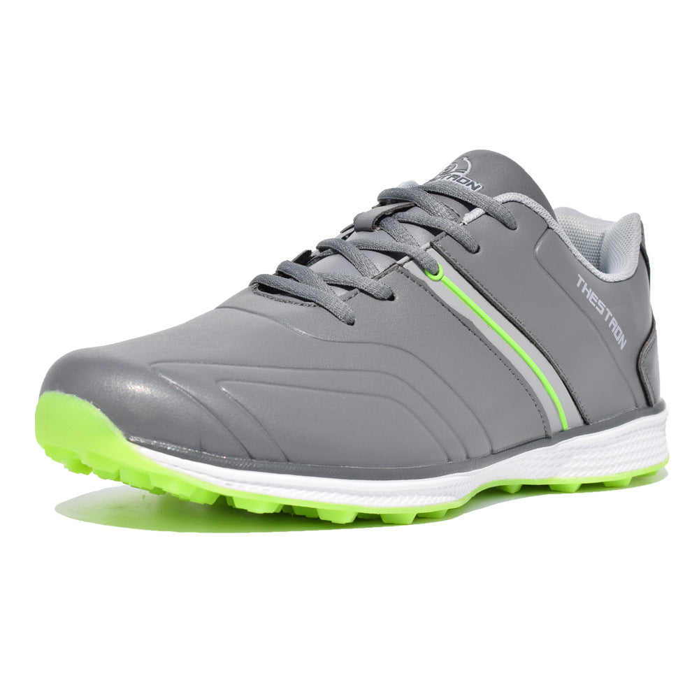 Gray athletic shoe with green sole on a white background