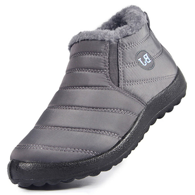 Gray winter slip-on shoe with black sole on a white background