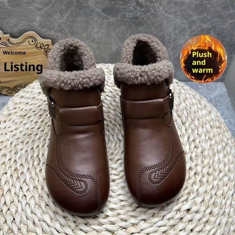 Pair of brown boots with fluffy gray lining on a textured surface.