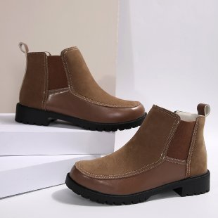Pair of brown leather ankle boots on a white background