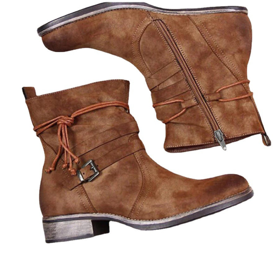 Pair of brown leather boots with a buckle on a white background