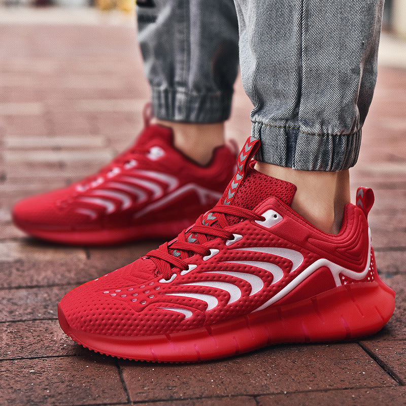 Red running shoes with white accents worn on a brick pavement