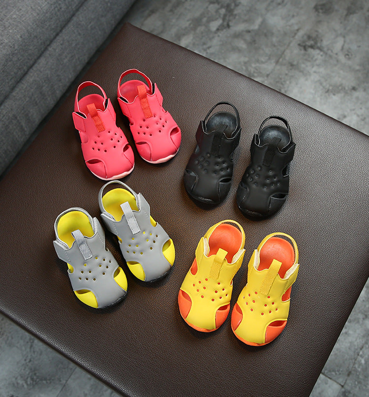 Set of colorful children's sandals on a brown surface.