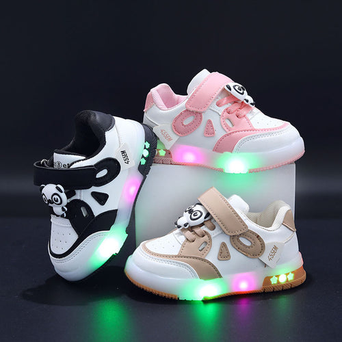 Three pairs of colorful children's sneakers with LED lights on a black background