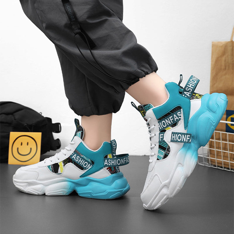 White and blue sneakers with 'FIONFAS' branding worn by a person on a gray surface.