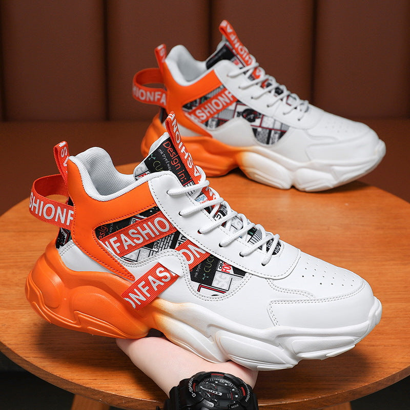 White sneakers with orange accents and 'FASHION' straps on a wooden surface.
